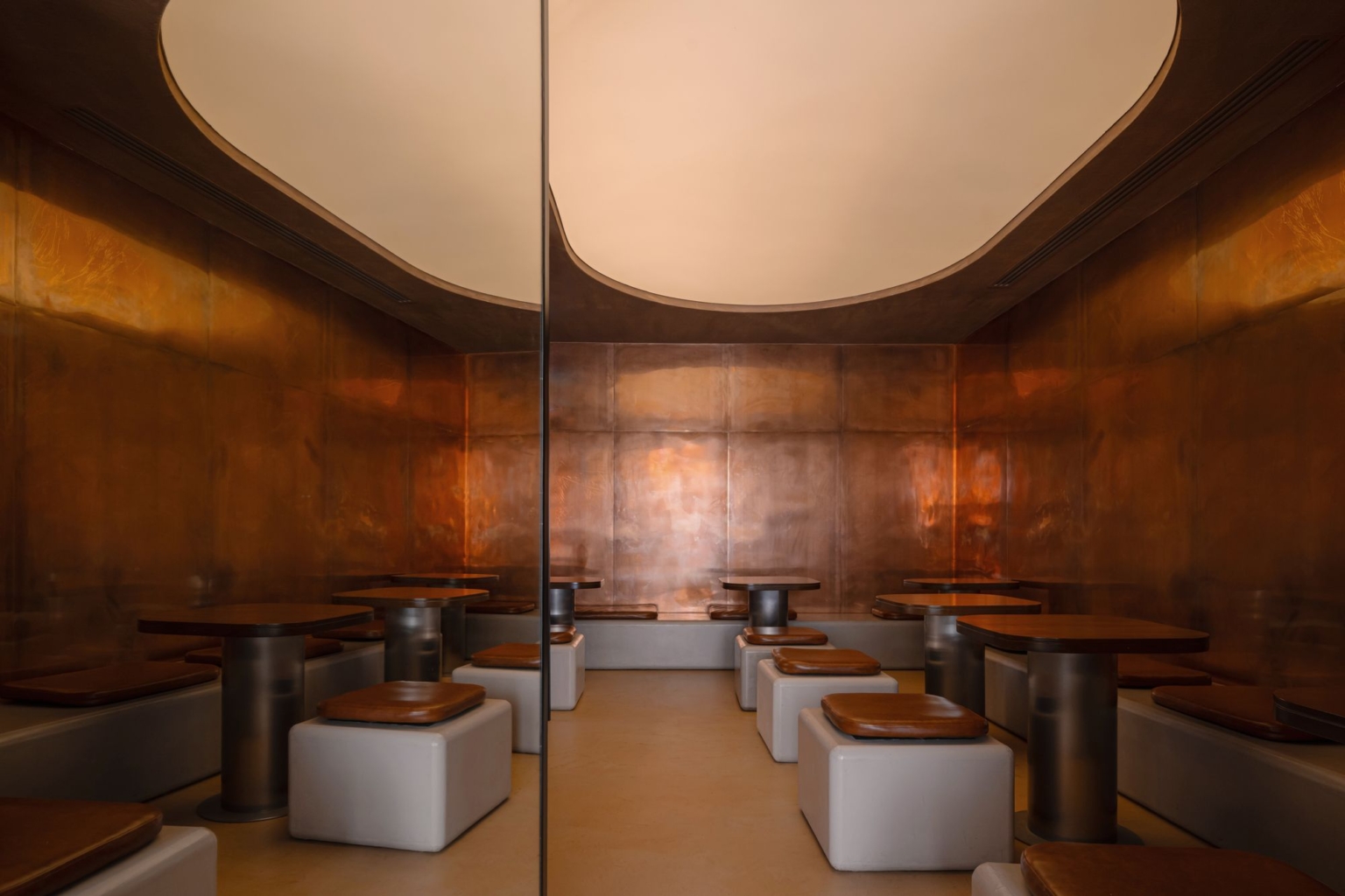 Dining room under a sculpted copper ceiling