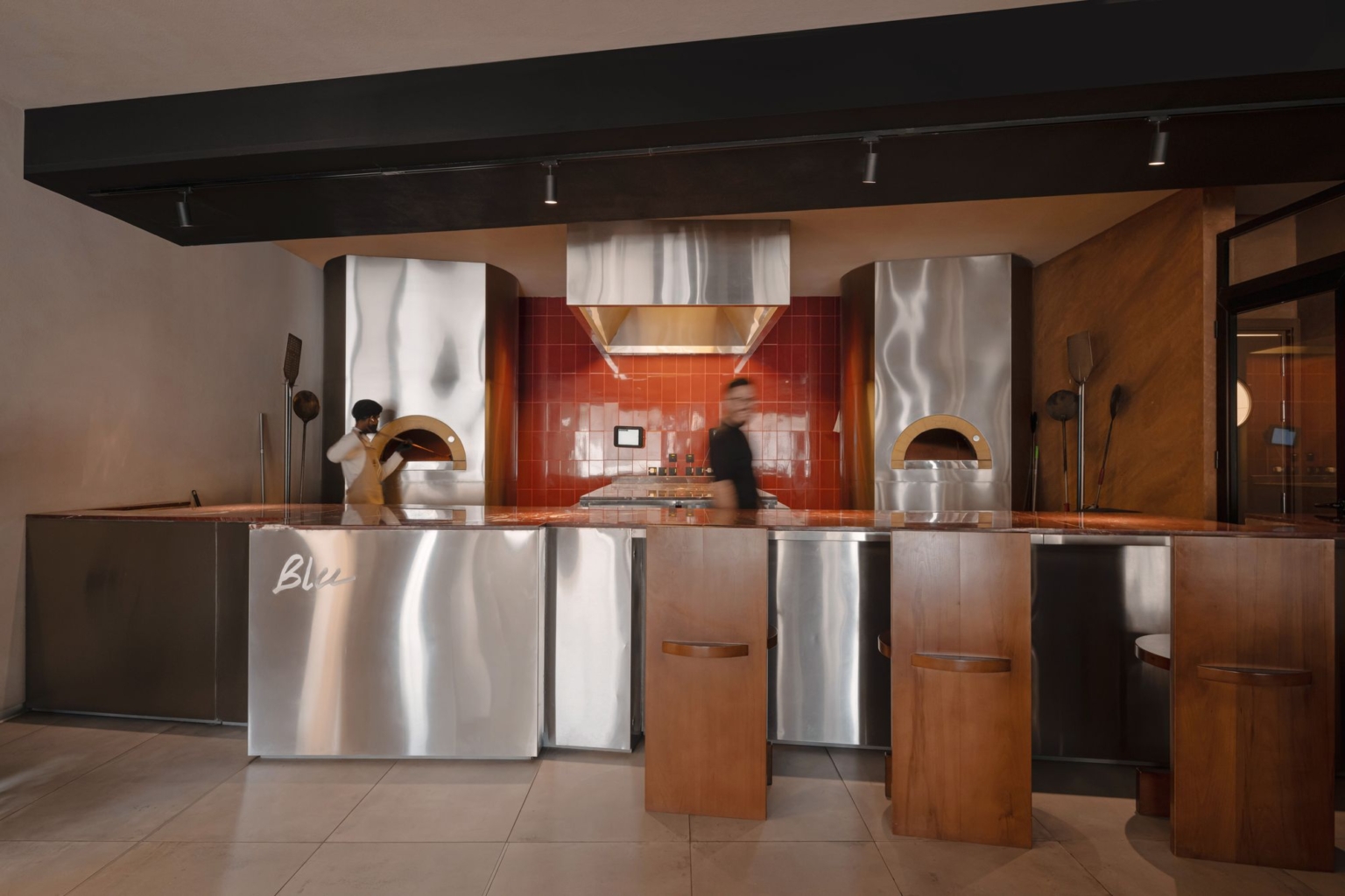 Stainless open kitchen with two wood-fired ovens