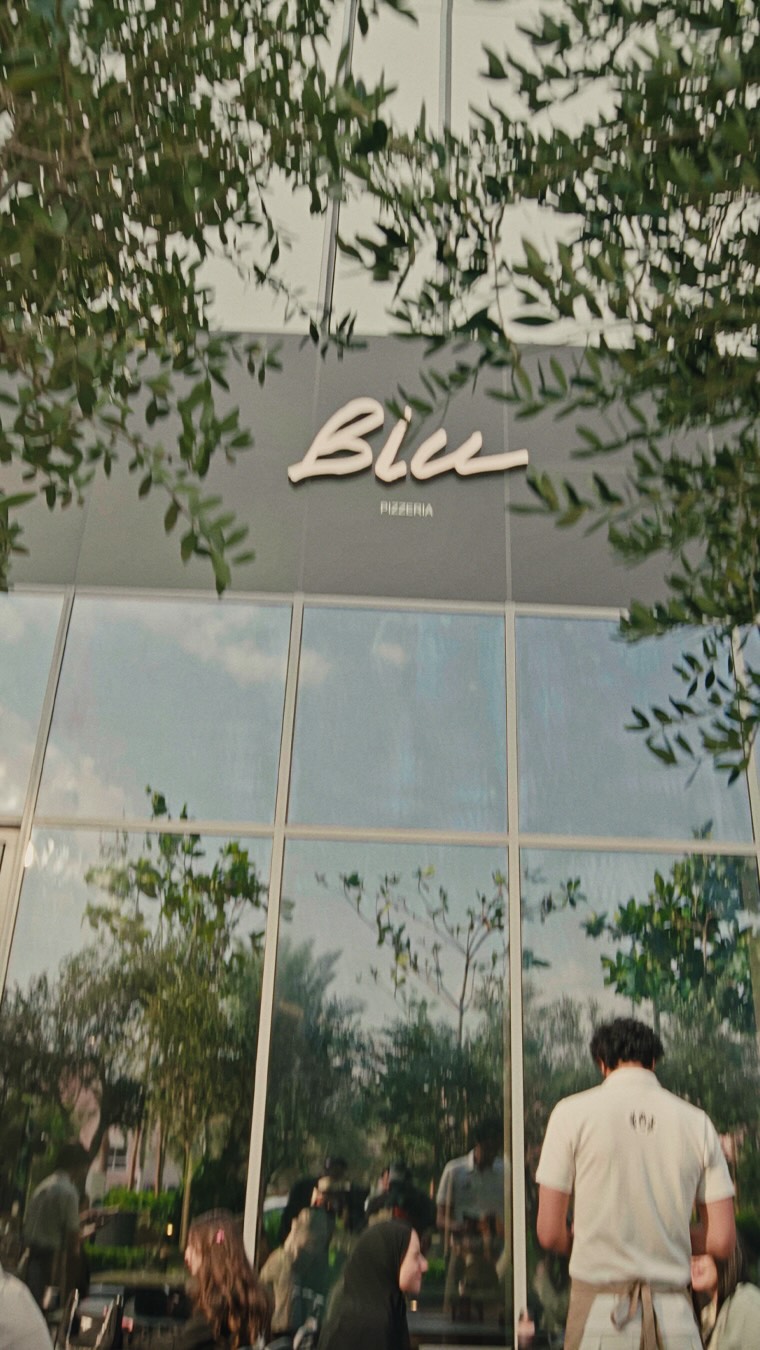 Guests outside a Blu storefront